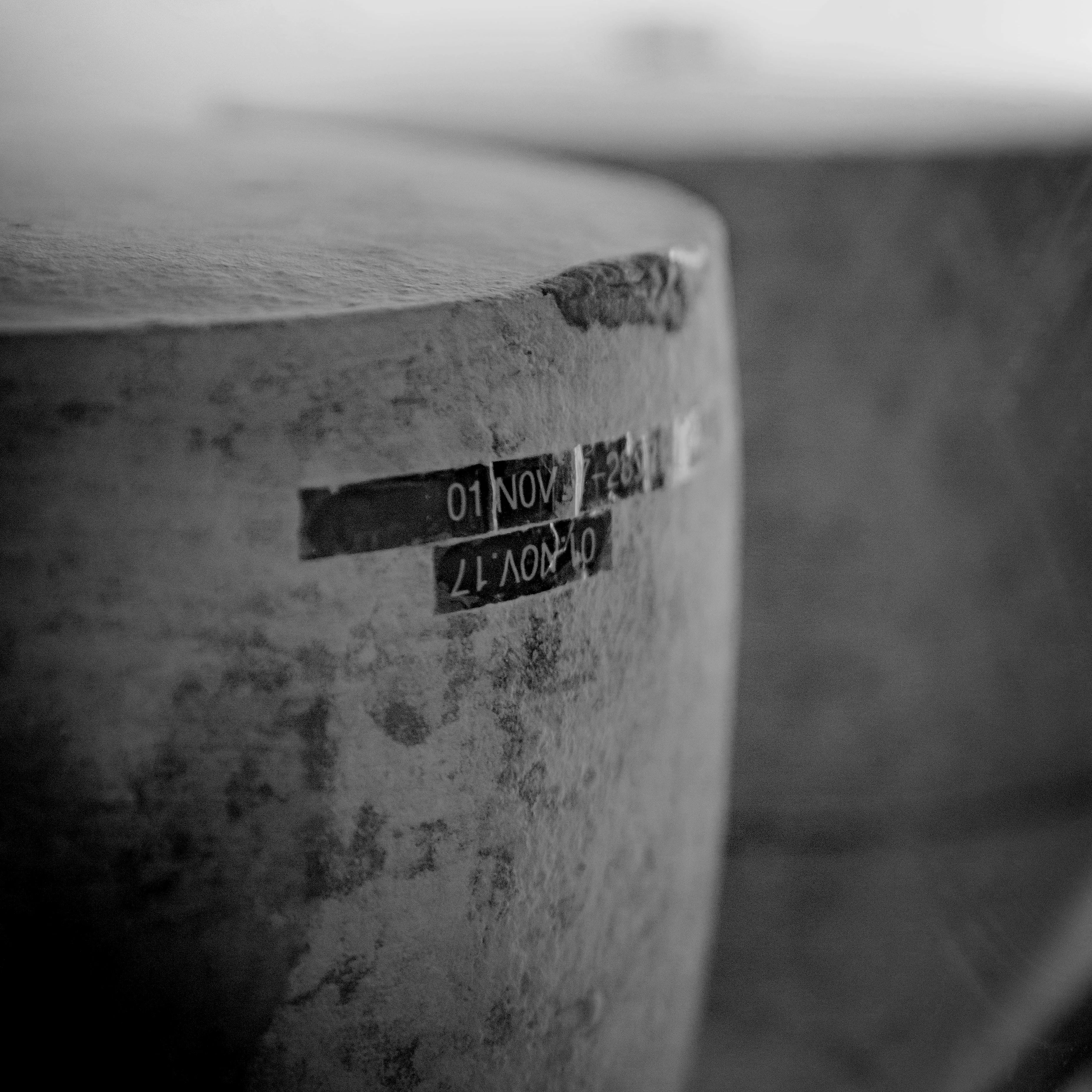 Close-up of a block of Cheddar cheese with visible date stamp