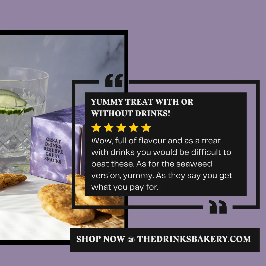 Promotional graphic for The Drinks Bakery featuring a purple box of snacks next to a glass of water with cucumber, with a large text overlay describing the product as 'Yummy Treat with or without Drinks!'.