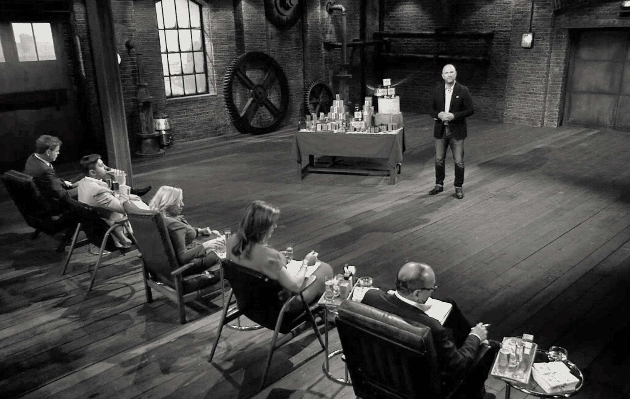 Entrepreneur, Andy Murray, pitches Drinks Biscuits, display to five investors on Dragon's Den set inside an industrial studio.