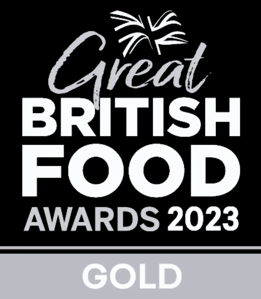 Award badge for Great British Food Awards 2023, with white text on a black background and a gray band at the bottom labeled GOLD.